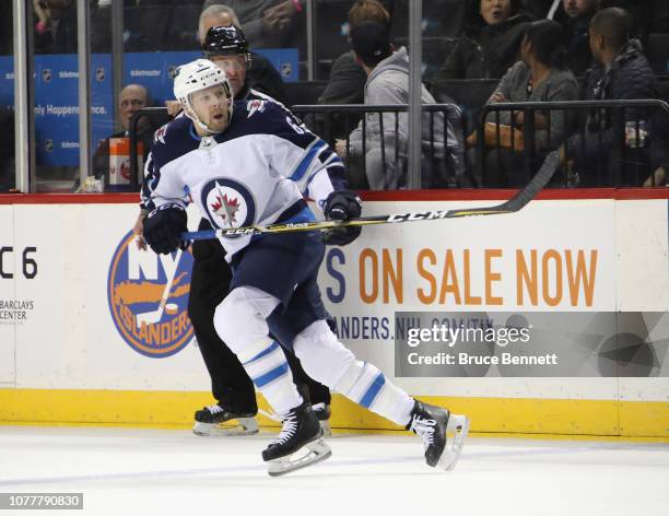 Cameron Schilling of the Winnipeg Jets skates against the New York Islanders at the Barclays Center on December 04, 2018 in the Brooklyn borough of...