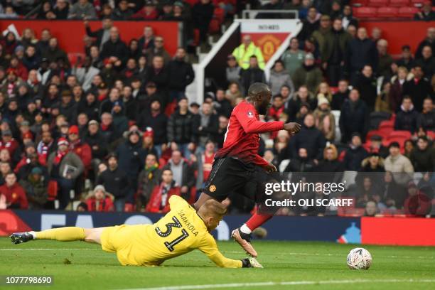 Manchester United's Belgian striker Romelu Lukaku touches the ball past Reading's Finnish goalkeeper Anssi Jaakkola to score their second goal during...