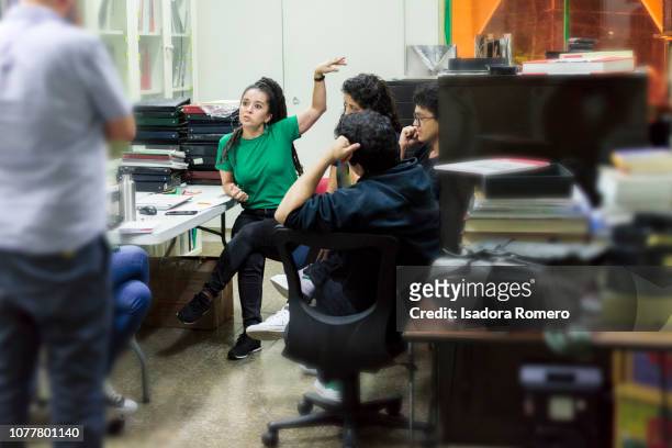 Latina woman working at the offfice in a meeting