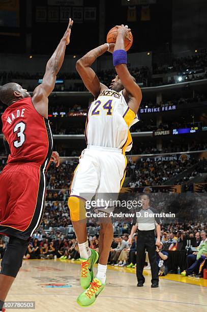 Kobe Bryant of the Los Angeles Lakers shoots against Dwyane Wade of the Miami Heat at Staples Center on December 25, 2010 in Los Angeles, California....