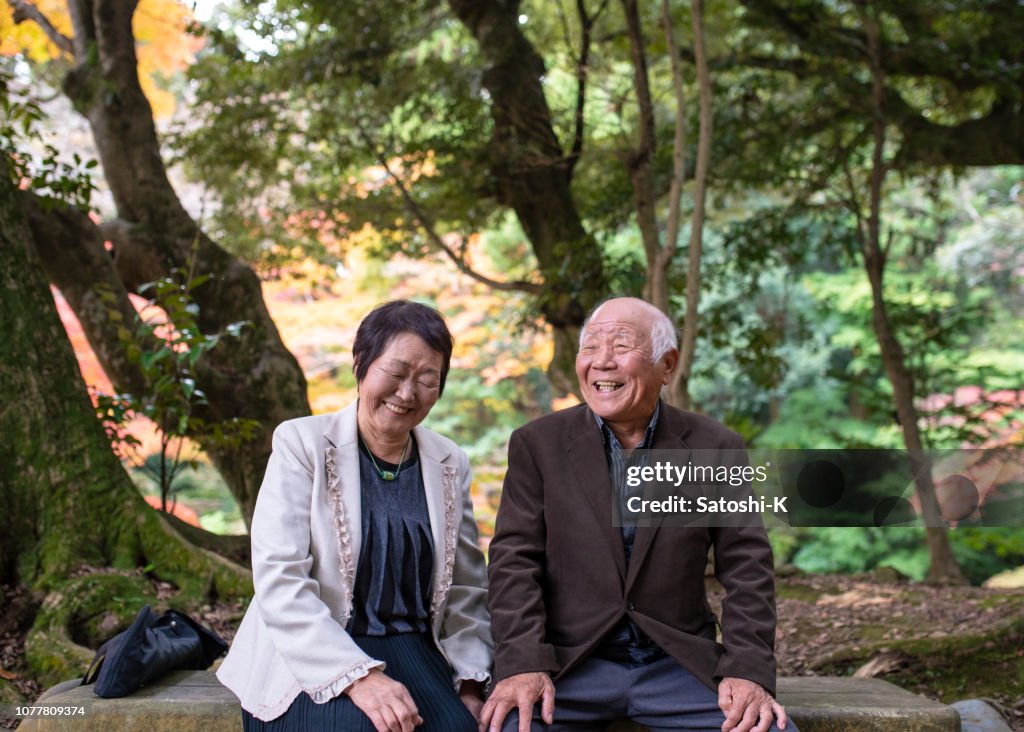 Happy senior couple taking a break in forest