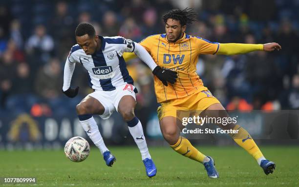 Player Kyle Edwards holds off the challenge oif Reece James of Wigan during the FA Cup Third Round match between West Bromwich Albion and Wigan...