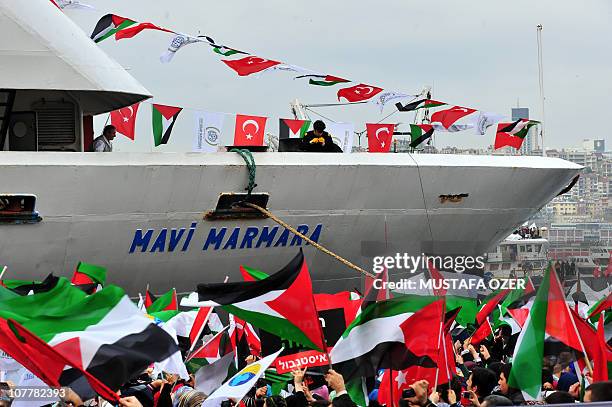 Turkish ship Mavi Marmara arrives at Istanbul's Sarayburnu port as people wave Turkish and Palestinian flags on December 26, 2010. The Israeli navy...