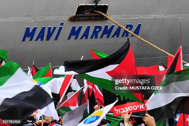 Turkish ship Mavi Marmara arrives at Istanbul's Sarayburnu port as people wave Turkish and Palestinian flags on December 26, 2010. The Israeli navy...