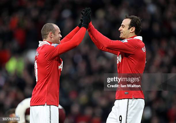 Dimitar Berbatov of Manchester United celebrates scoring the opening goal with team mate Wayne Rooney during the Barclays Premier League match...