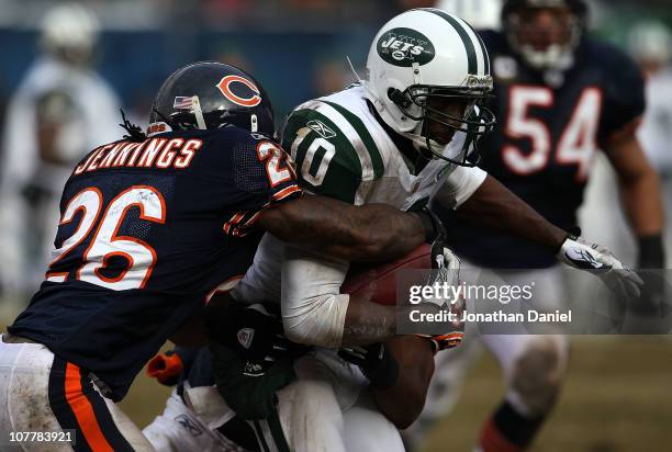 Tim Jennings and Nick Roach of the Chicago Bears bring down Santonio Holmes of the New York Jets at Soldier Field on December 26, 2010 in Chicago,...