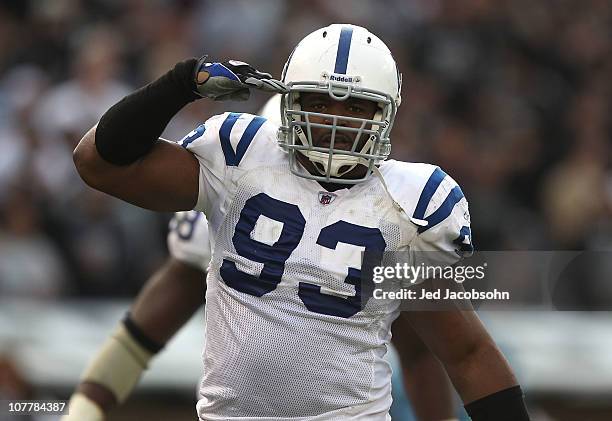 Dwight Freeney of the Indianapolis Colts celebrates after a sack against the Oakland Raiders during an NFL game at Oakland-Alameda County Coliseum on...