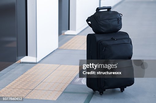 Carry on luggage waiting for delay train in platform Carry on luggage waiting for delay train in platform