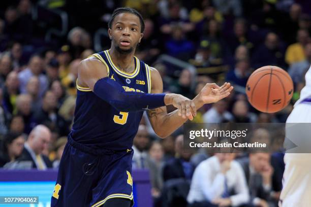 Zavier Simpson of the Michigan Wolverines passes the ball in the game against the Northwestern Wildcats in the first half at Welsh-Ryan Arena on...