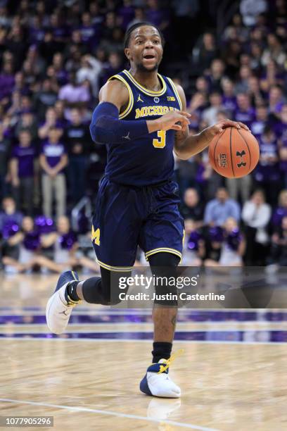 Zavier Simpson of the Michigan Wolverines brings the ball up the court in the game against the Northwestern Wildcats in the first half at Welsh-Ryan...