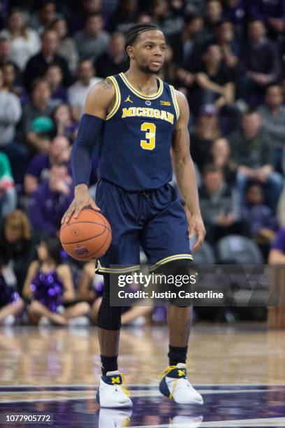 Zavier Simpson of the Michigan Wolverines brings the ball up the court in the game against the Northwestern Wildcats in the first half at Welsh-Ryan...