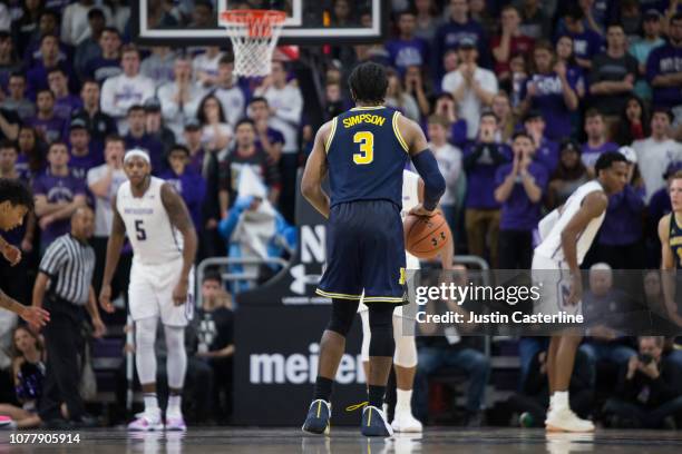 Zavier Simpson of the Michigan Wolverines brings the ball up the court in the game against the Northwestern Wildcats in the first half at Welsh-Ryan...