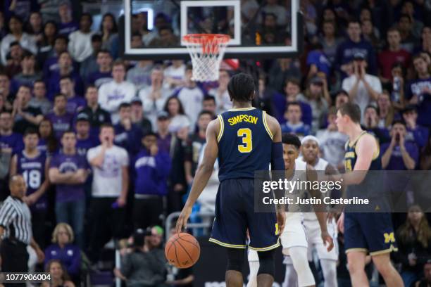 Zavier Simpson of the Michigan Wolverines brings the ball up the court in the game against the Northwestern Wildcats in the second half at Welsh-Ryan...