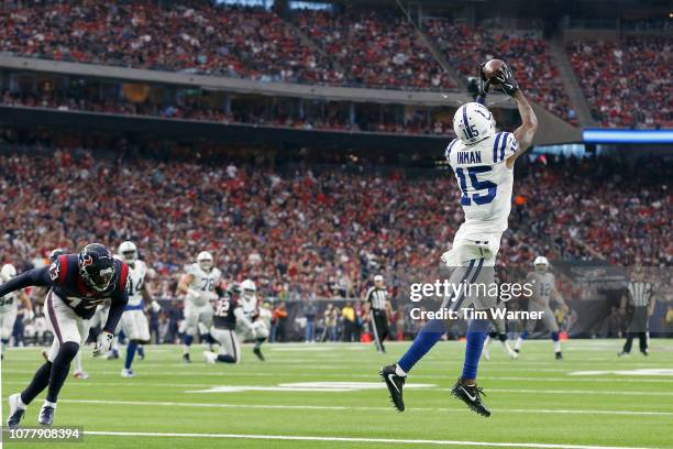 Dontrelle Inman of the Indianapolis Colts catches a pass for a touchdown defended by Shareece Wright of the Houston Texans in the second quarter...