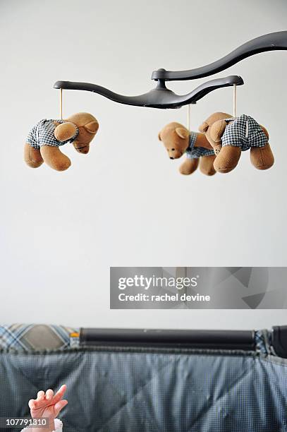 baby reaches for mobile - baby crib stockfoto's en -beelden