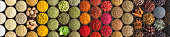 Various spices and herbs as a background. Colorful condiments in cups, top view