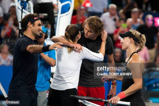 Belinda Bencic of Switzerland is hugged by Alexander Zverev of Germany as Bencic's compatriot Roger Federer and Zverev's compatriot Angelique Kerber...