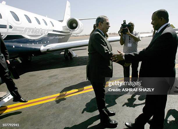 Sudanese foreign affairs cabinet minister of state Kamal el-Din Hassan Ali welcomes Arab League Secretary General Amr Mussa at Khartoum airport upon...