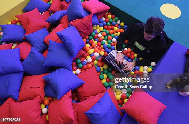 Participant sits with a laptop computer as he attends the annual Chaos Communication Congress of the Chaos Computer Club at the Berlin Congress...