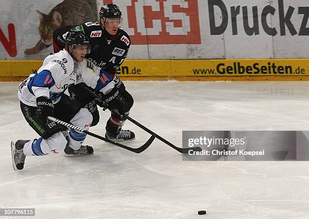 Philip Gogulla of Koelner Haie challenges Tim Hambly of Ingolstadt during the DEL match between Koelner Haie and ERC Ingolstadt at Lanxess Arena on...