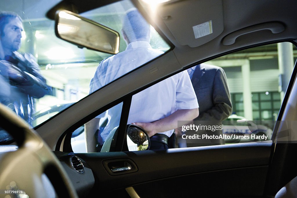 Emergency on-call doctor talking with police officer