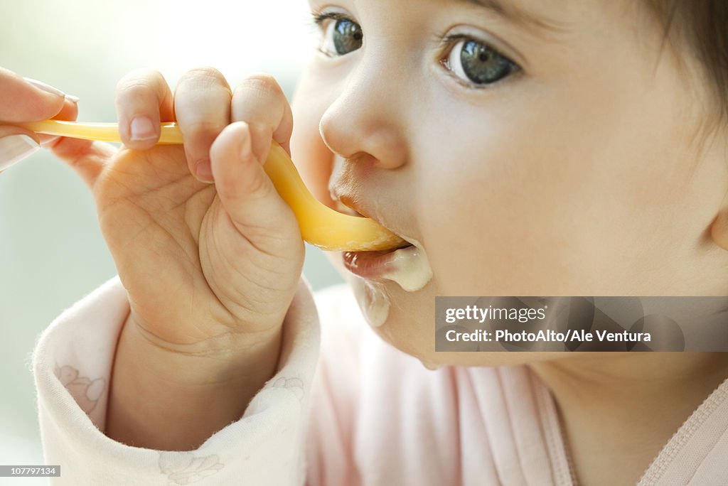 Infant learning to eat with a spoon