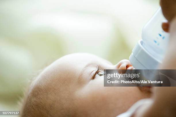 baby drinking from bottle - baby feeding stockfoto's en -beelden