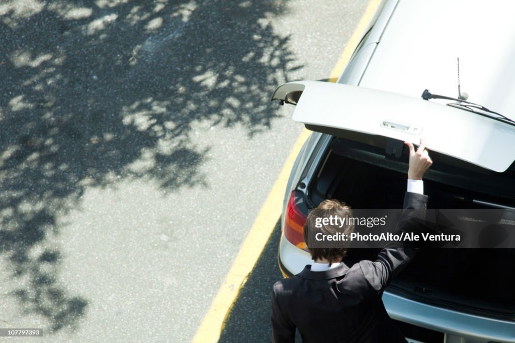 Man opening car hatchback