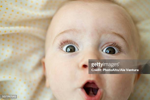 baby looking at camera with surprised expression, portrait - open day 1 stock pictures, royalty-free photos & images