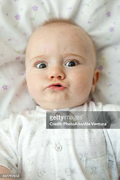 baby making faces at camera, portrait - hacer muecas fotografías e imágenes de stock