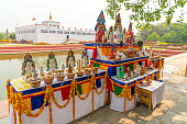 Buddha birthplace in Lumbini and buddhist offerings near sacred pond