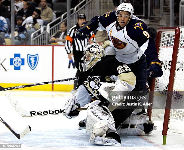Evander Kane of the Atlanta Thrashers crashes the net as Marc-Andre Fleury of the Pittsburgh Penguins makes a save at Consol Energy Center on...