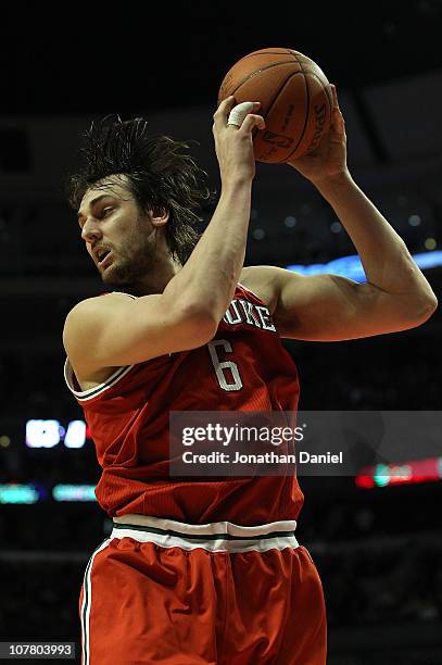 Andrew Bogut of the Milwaukee Bucks pulls down a rebound against the Chicago Bulls at the United Center on December 28, 2010 in Chicago, Illinois....