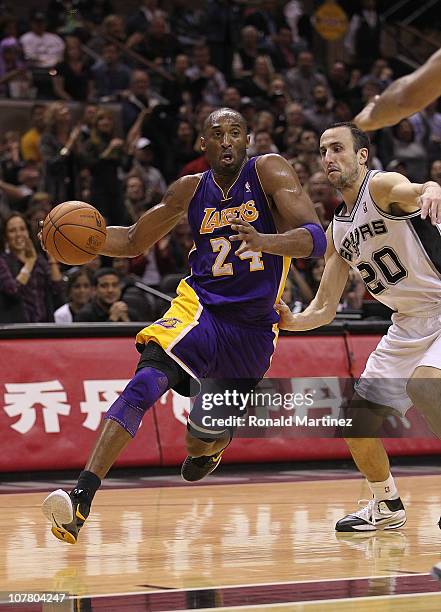 Guard Kobe Bryant of the Los Angeles Lakers dribbles the ball against Manu Ginobili of the San Antonio Spurs at AT&T Center on December 28, 2010 in...