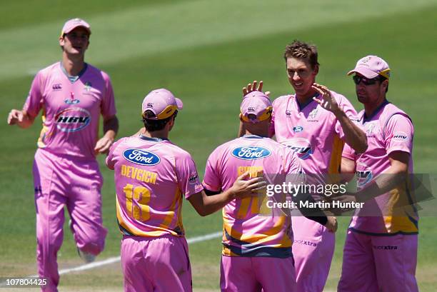 Brent Arnel of the Knights is congratulated by team mates during the HRV Cup Twenty20 match between the Canterbury Wizards and the Northern Knights...