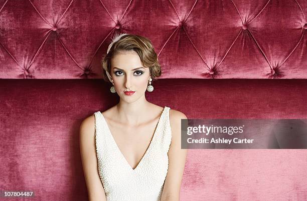 1920's bride on red velvet couch sofa - vintage dress stock pictures, royalty-free photos & images