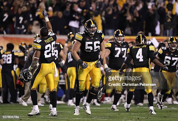 Shaun Prater, Markus Zusevics and Jordan Bernstine of the Iowa Hawkeyes celebrate after a turnover to the Missouri Tigers was overturned late in the...