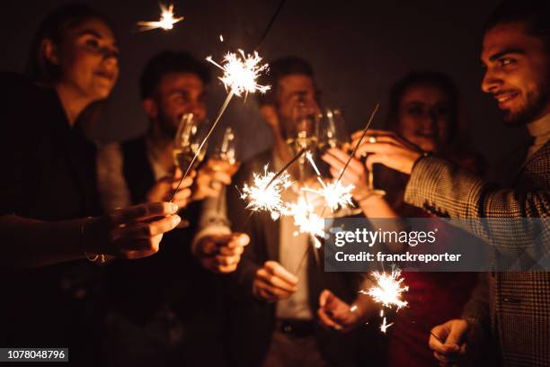 friends celebrate the new year on the rooftop - new years eve 2020 stock pictures, royalty-free photos & images