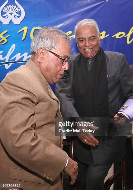 Finance Minister Pranab Mukherjee and senior BJP leader Yashwant Sinha during a function to celebrate 10 years of South Asian Free Media Association...
