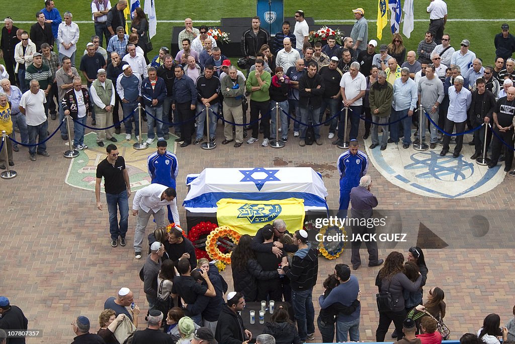 Family members hug close to the flag dra