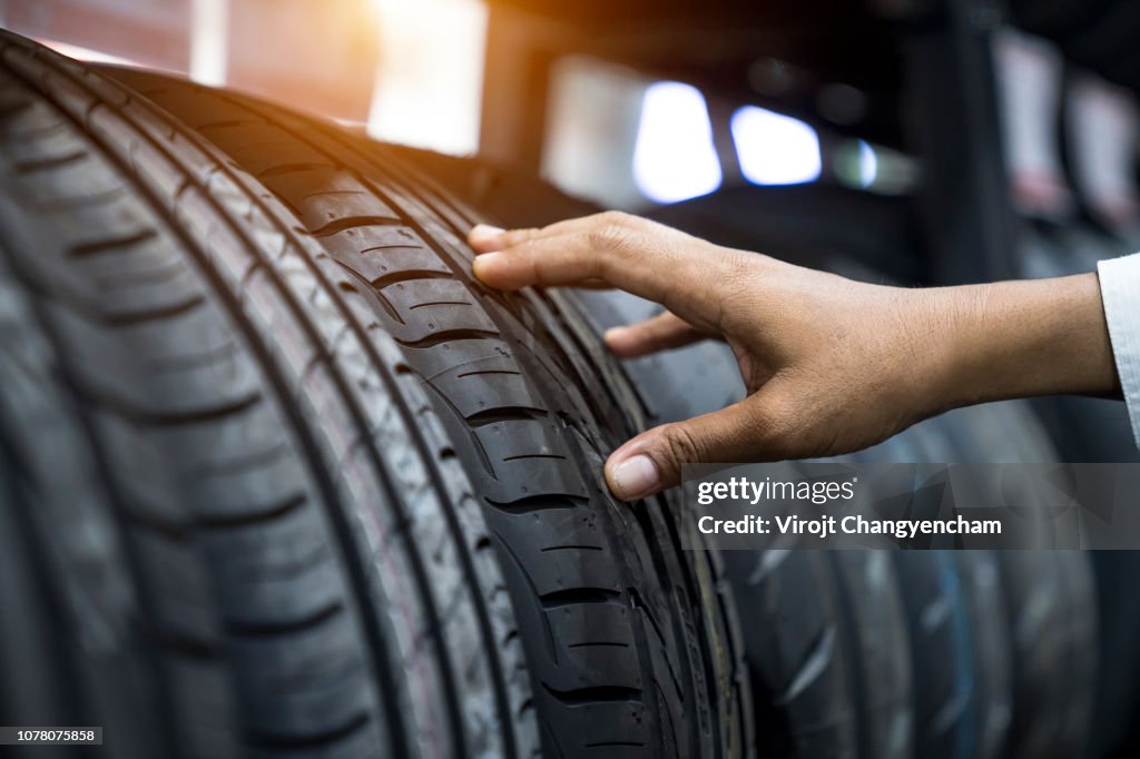Hand finger checking tire