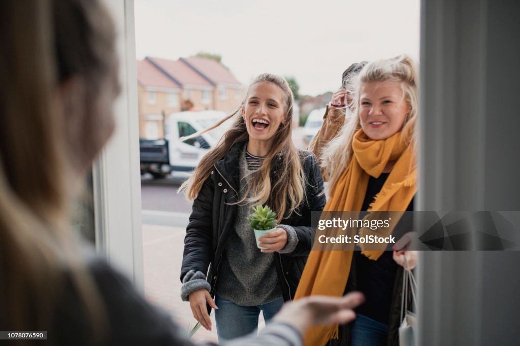 Greeting Guests at Housewarming Party