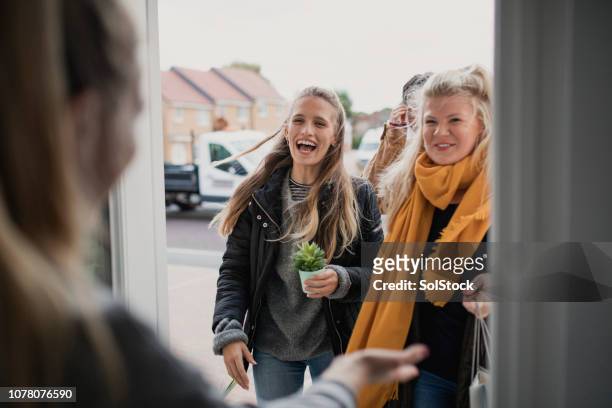 greeting guests at housewarming party - arrival stock pictures, royalty-free photos & images