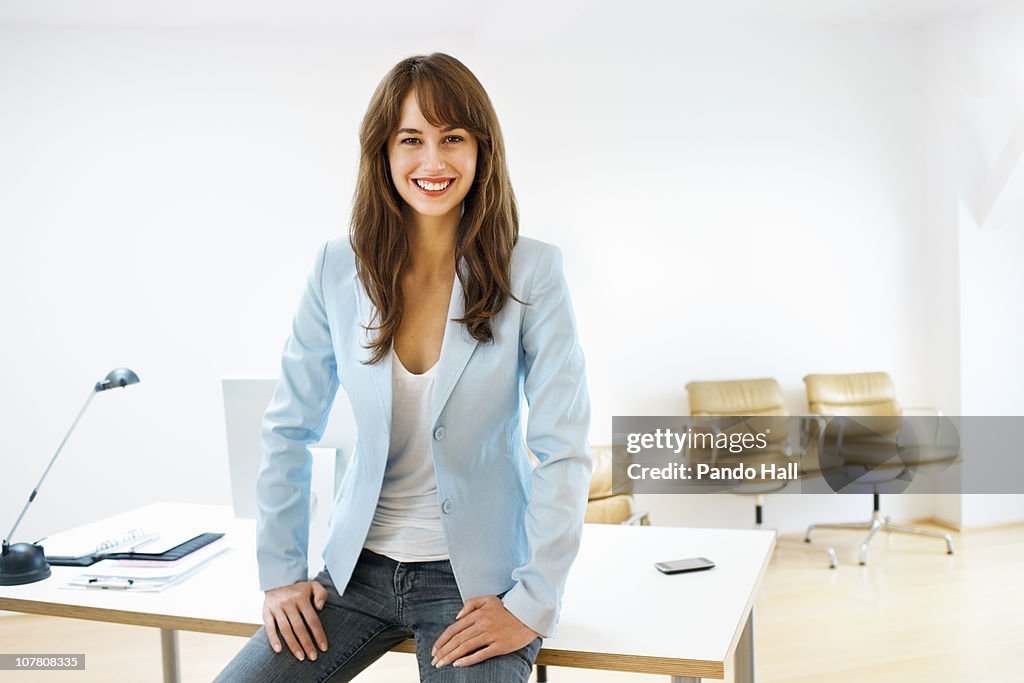 Portrait of a young woman in her office, smiling