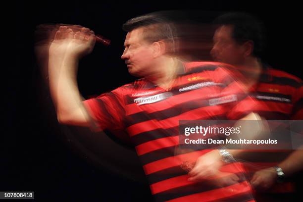 Dennis Priestley of England in action against Gary Anderson of Scotland during day 11 in the 2011 Ladbrokes.com World Darts Championship at Alexandra...