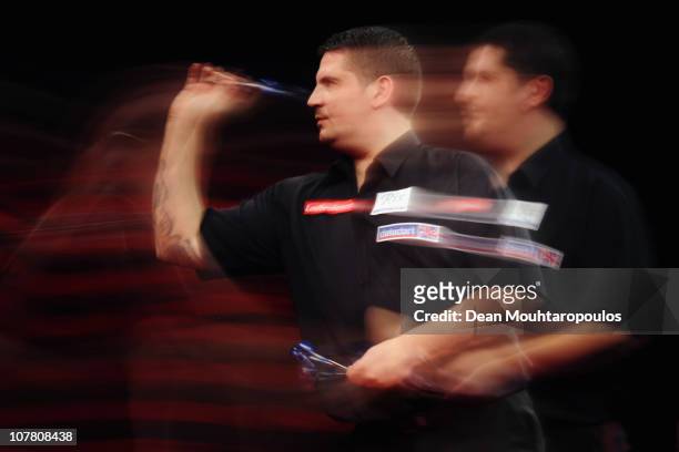 Gary Anderson of Scotland in action against Dennis Priestley of England during day 11 in the 2011 Ladbrokes.com World Darts Championship at Alexandra...