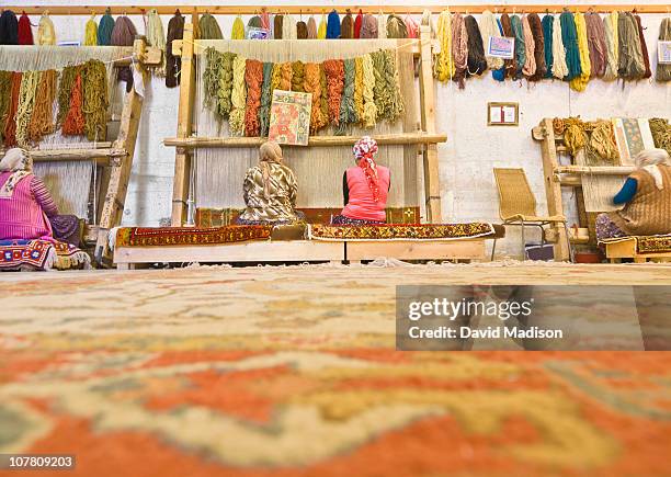 women weaving turkish carpets. - david weaver stock pictures, royalty-free photos & images