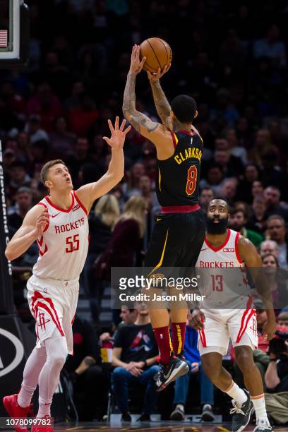 Isaiah Hartenstein and James Harden of the Houston Rockets attempt to block Jordan Clarkson of the Cleveland Cavaliers during the first half at...