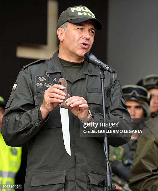 National Police Chief Gen. Oscar Naranjo, holds a knife seized to Colombian drug lord and former paramilitary leader Pedro Guerrero Castillo, known...