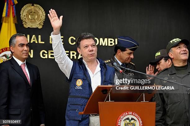 Colombia's President Juan Manuel Santos waves, flanked by Defense Minister Rodrigo Rivera , Colombian Air Force Commander Gen.Julio Alberto Gonzalez...